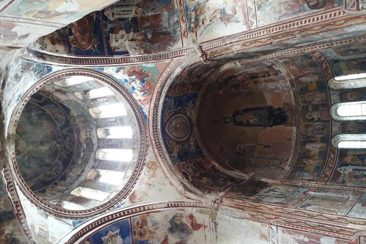 a view of the ceiling of a church with paintings