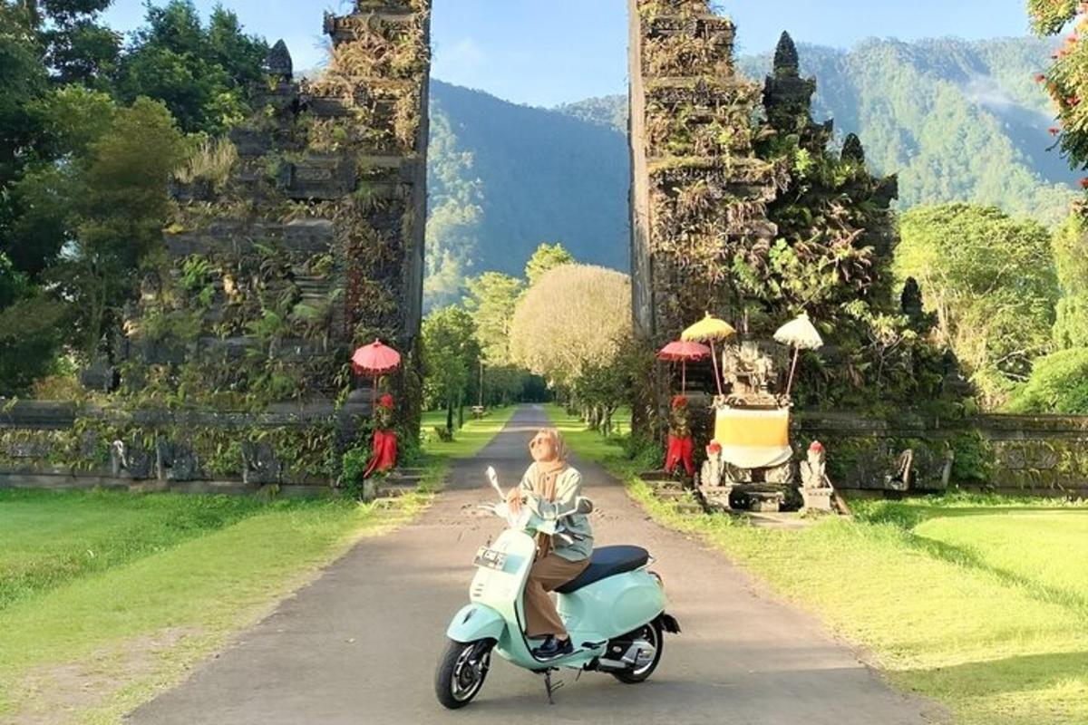una dona que va en scooter davant d'un temple