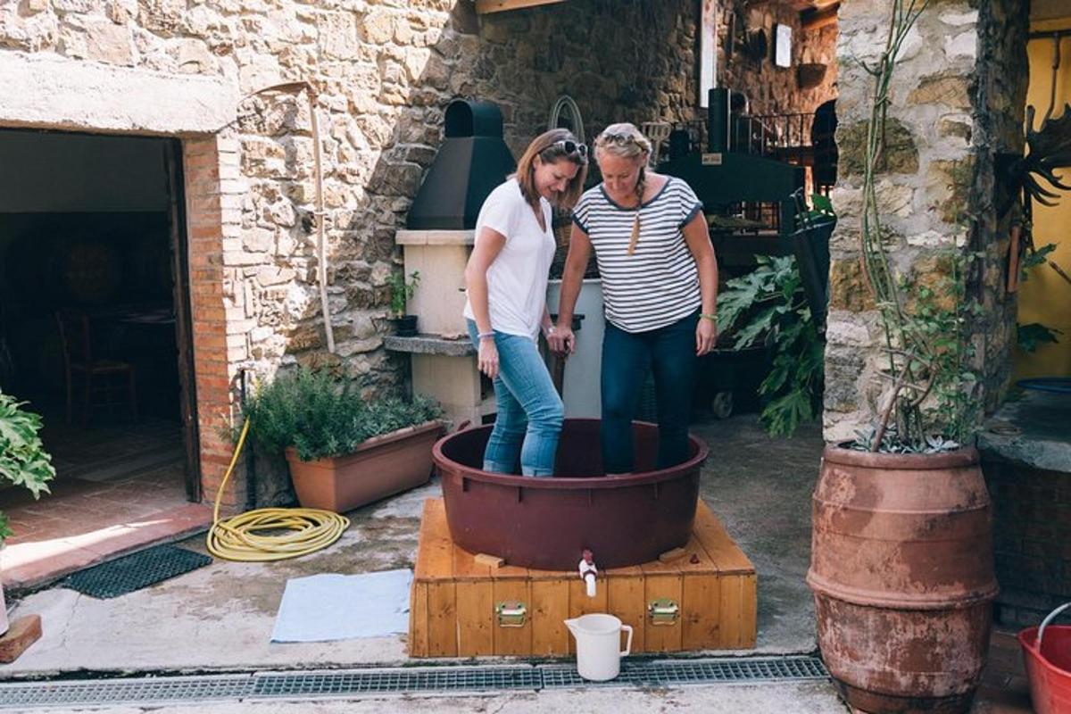 two women are standing in a large pot