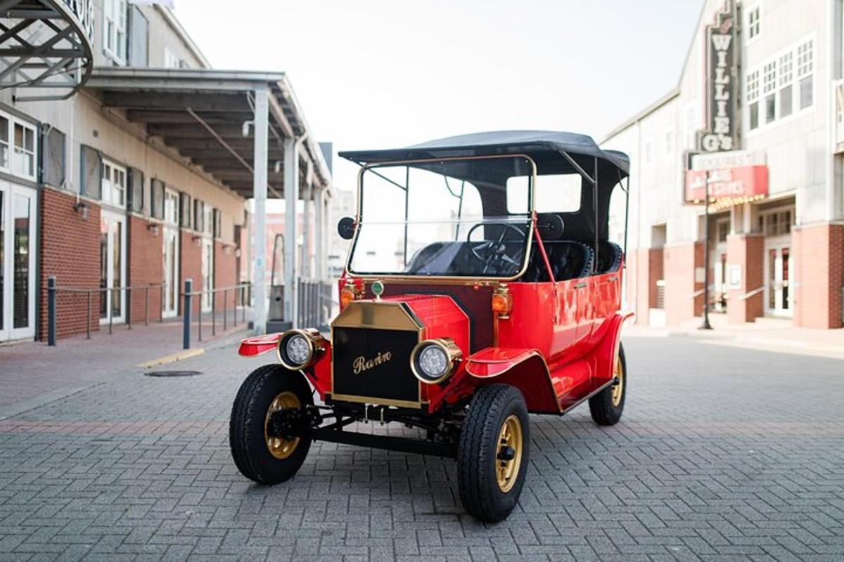 an old red car is parked on a street