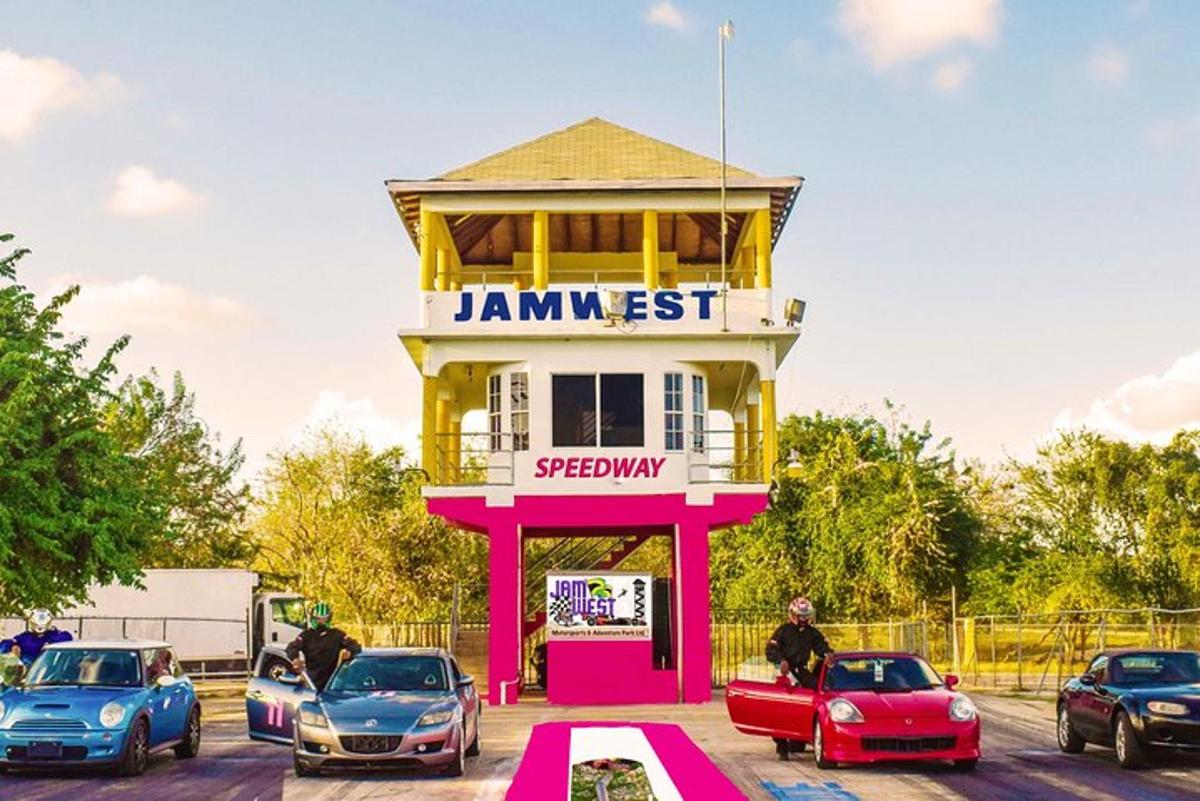 a pink and yellow building with cars parked in a parking lot