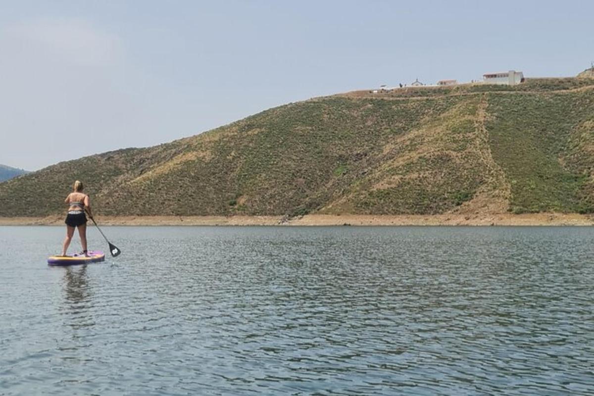a woman on a paddle board on a lake