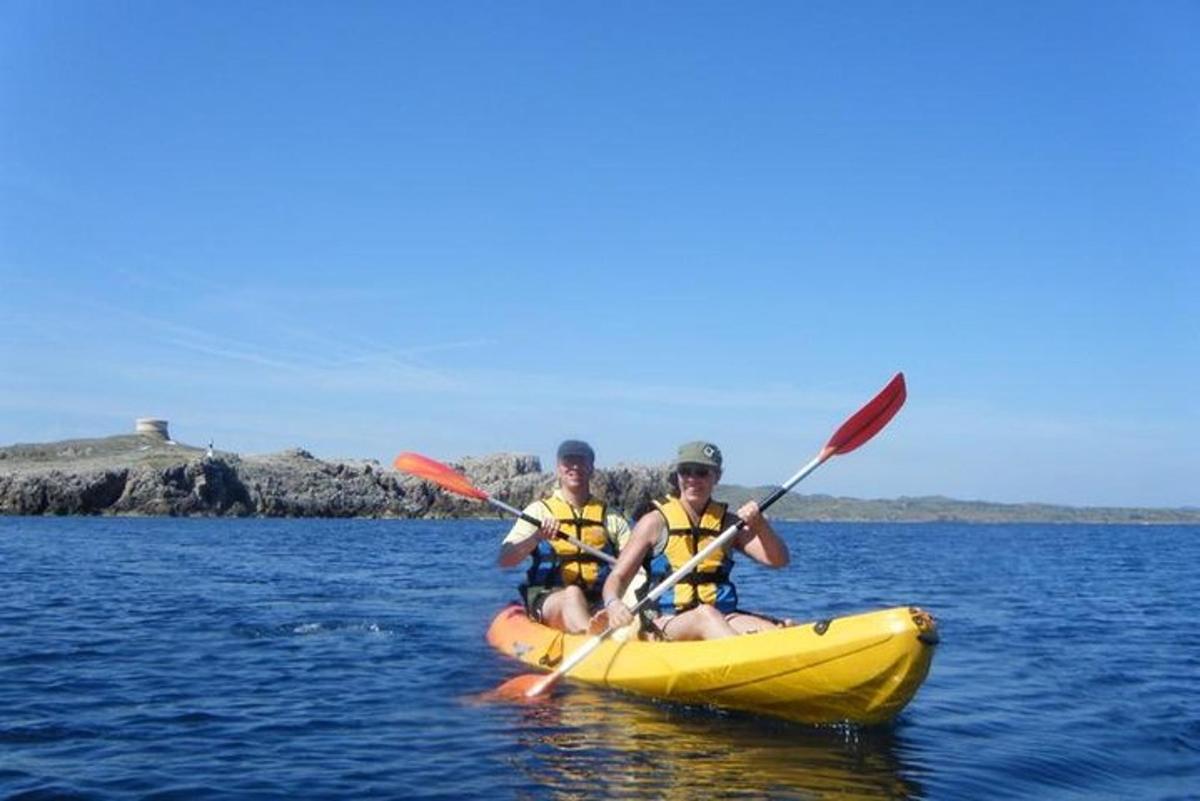 two people in a yellow kayak on the water