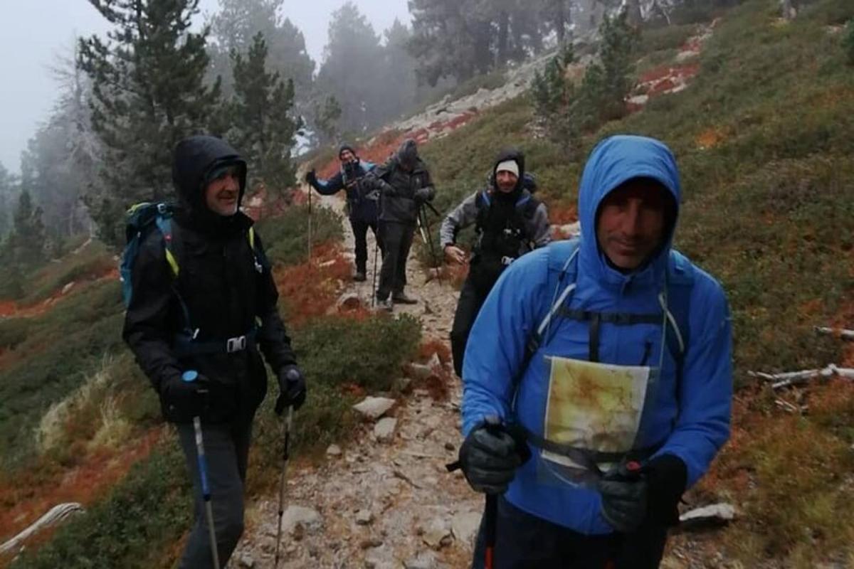 a group of people walking on a mountain trail