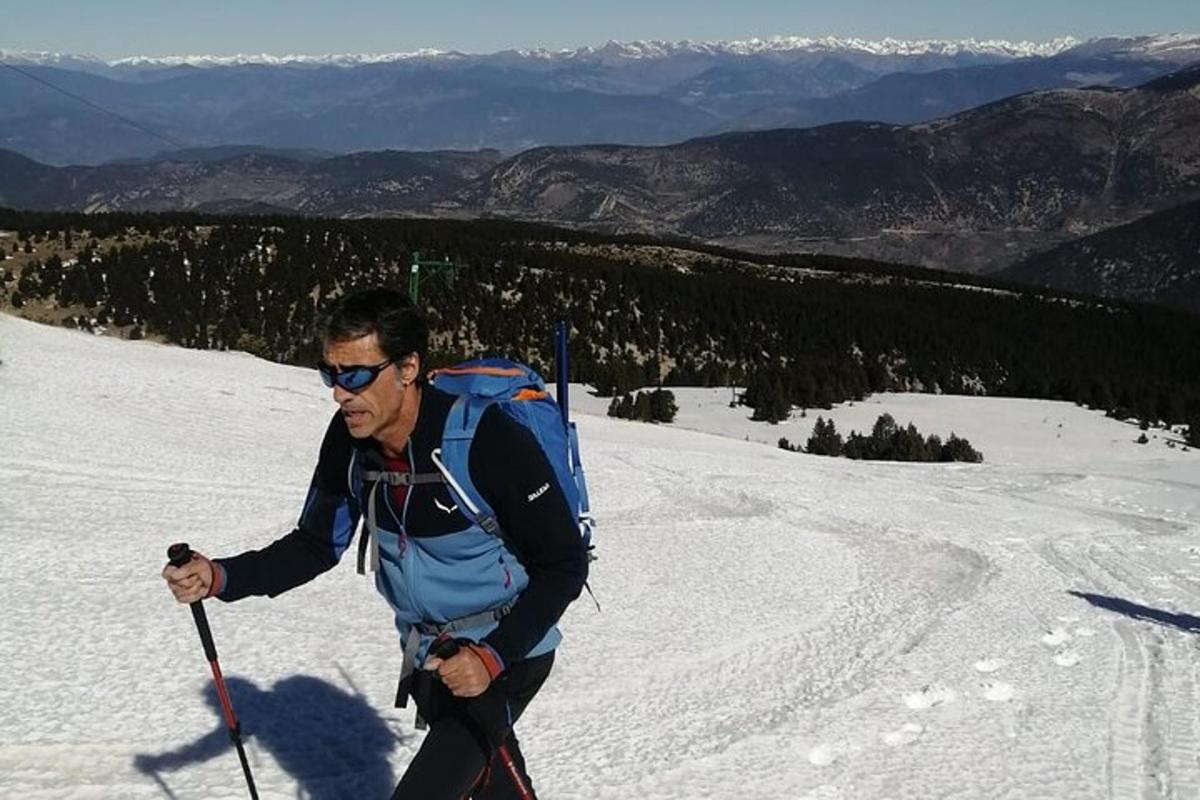 a man on skis in the snow on a mountain