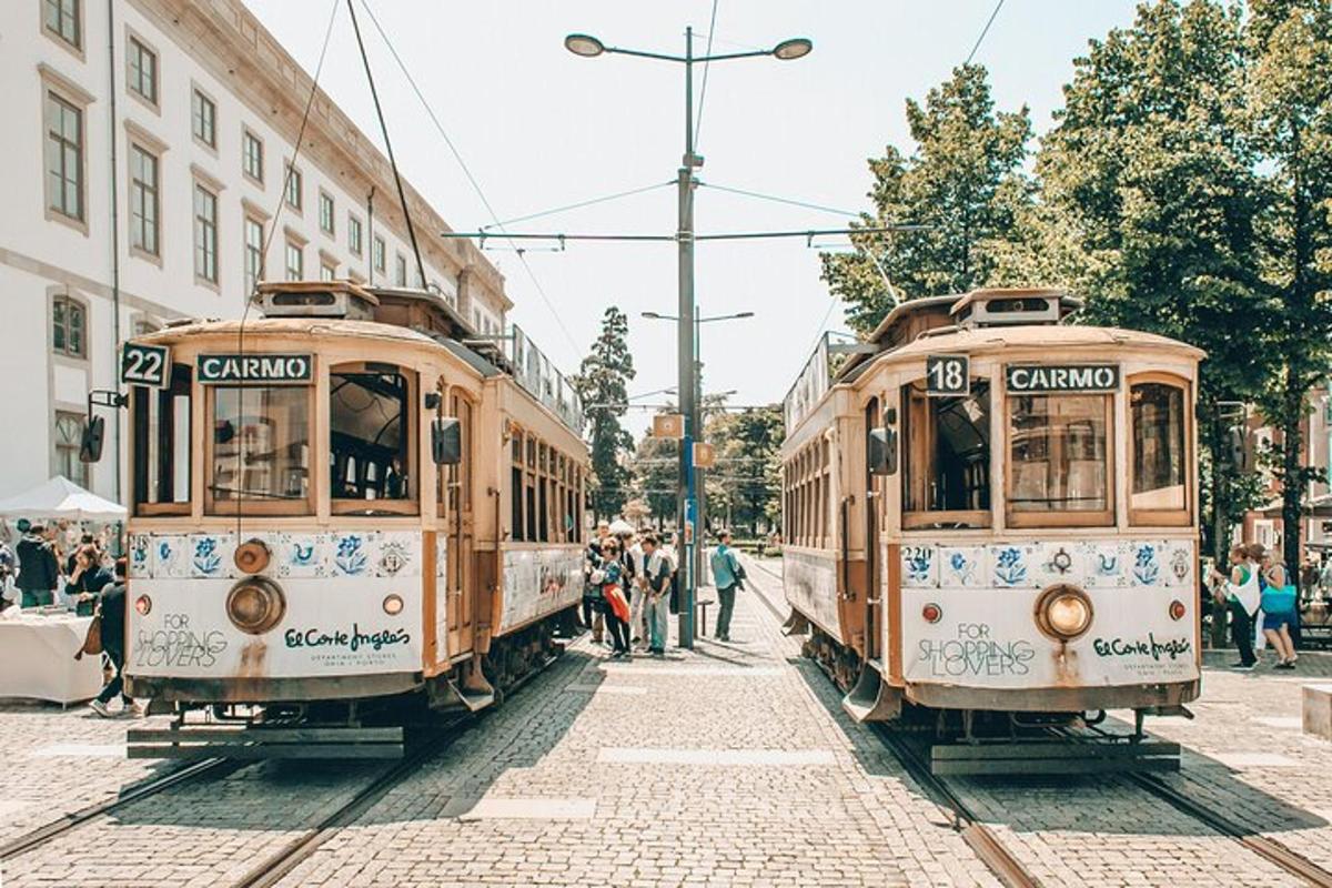 two trolley cars parked next to each other on a street
