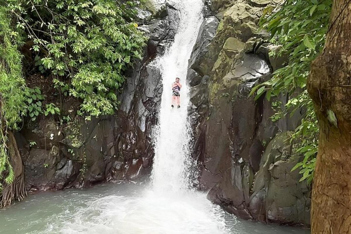 a person standing in front of a waterfall