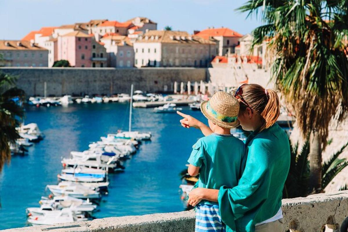 a woman and child looking at boats in a marina