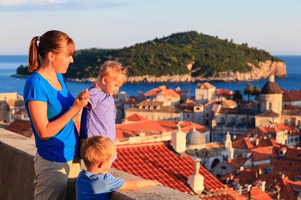 a woman and two children standing on top of a city