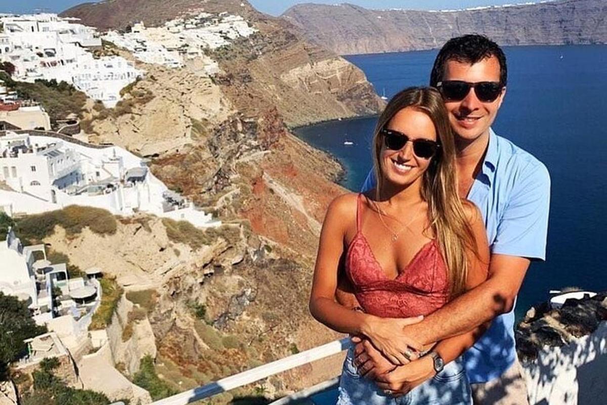 a man and a woman standing on top of a mountain
