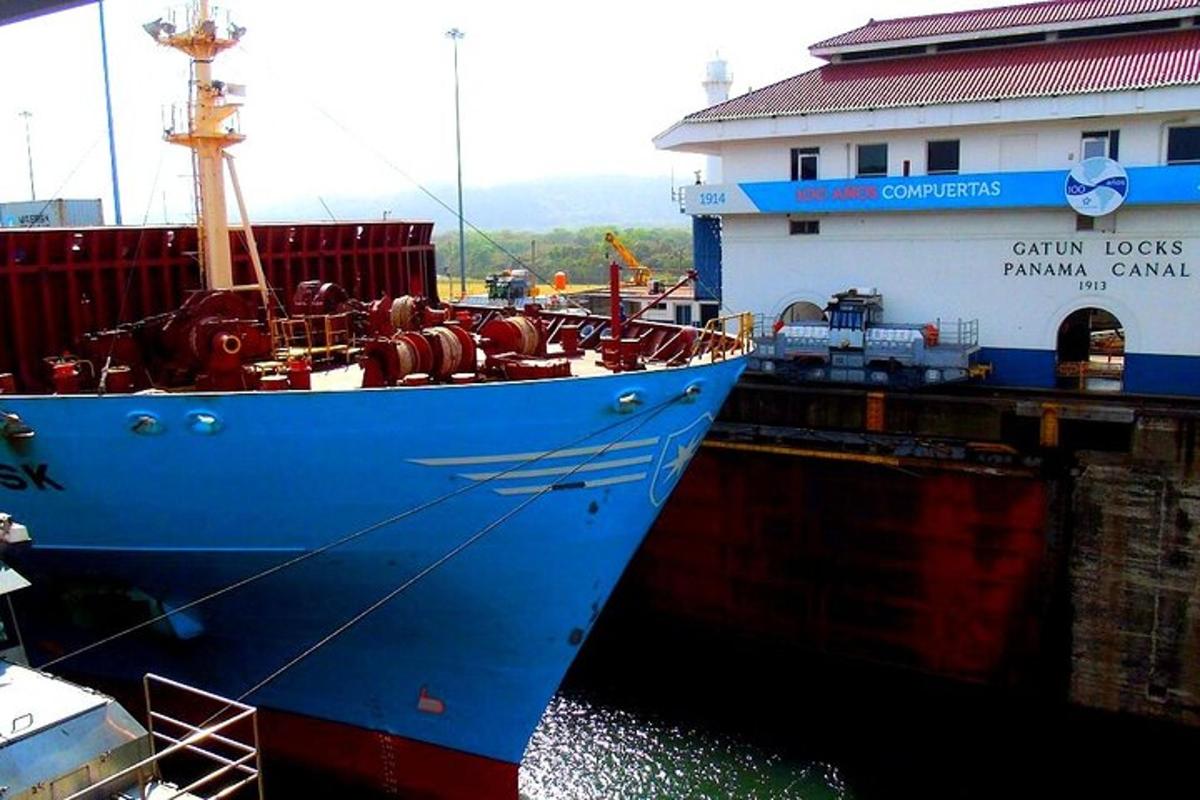 a large blue ship is docked in the water