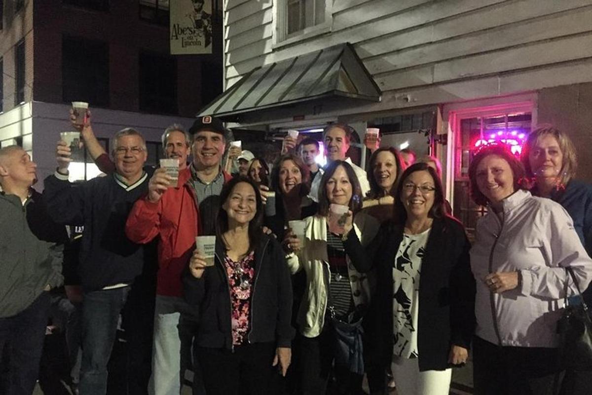 a group of people posing for a picture with their cell phones