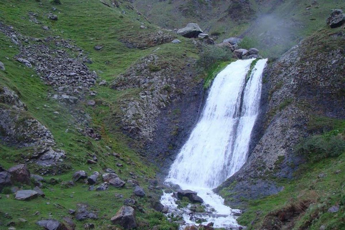 a waterfall on the side of a mountain