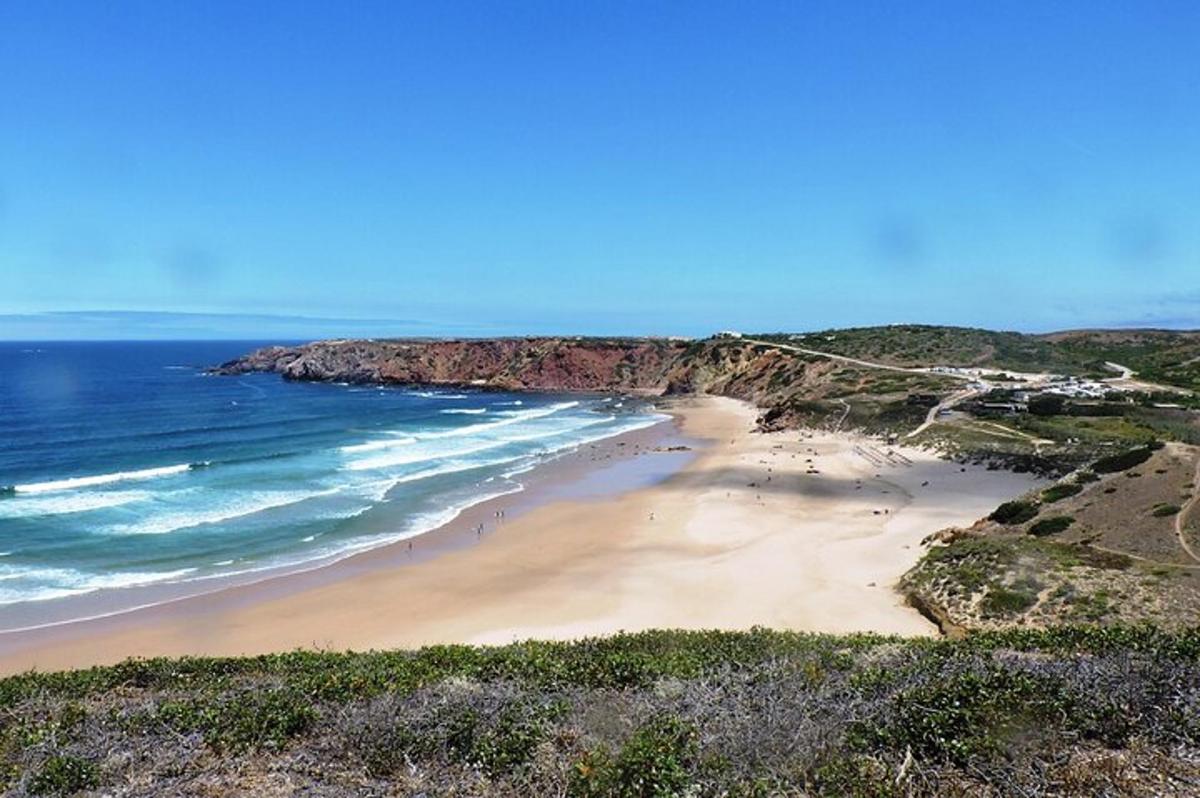 a beach with a group of people on the sand