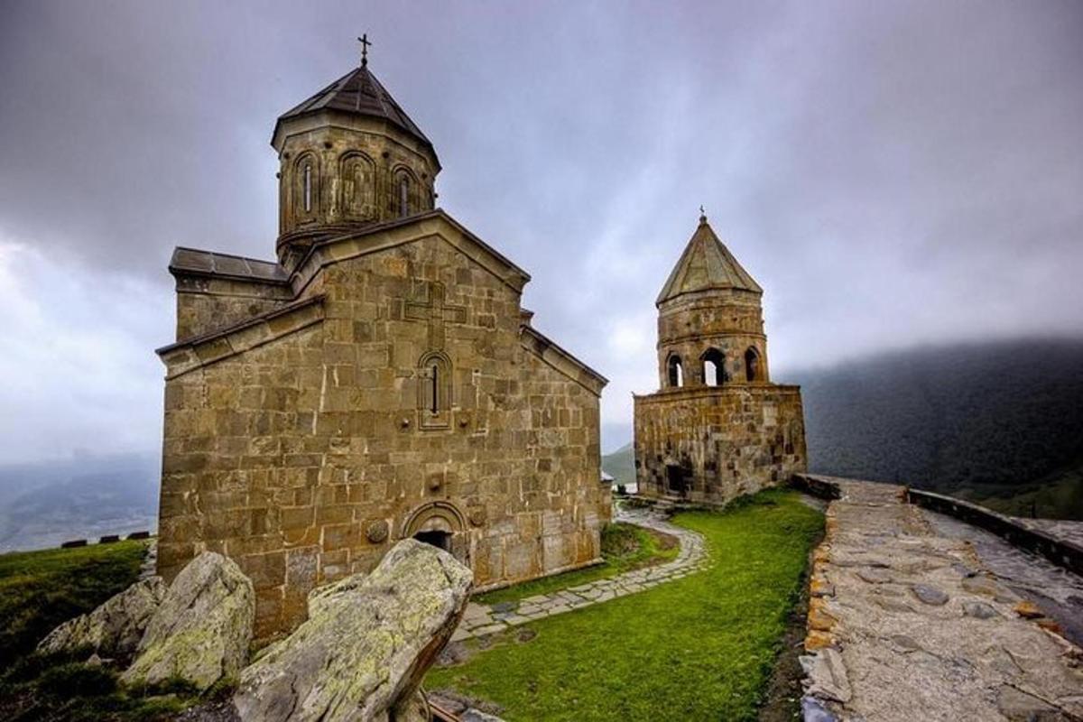en gammel steinkirke med to tårn på en høyde