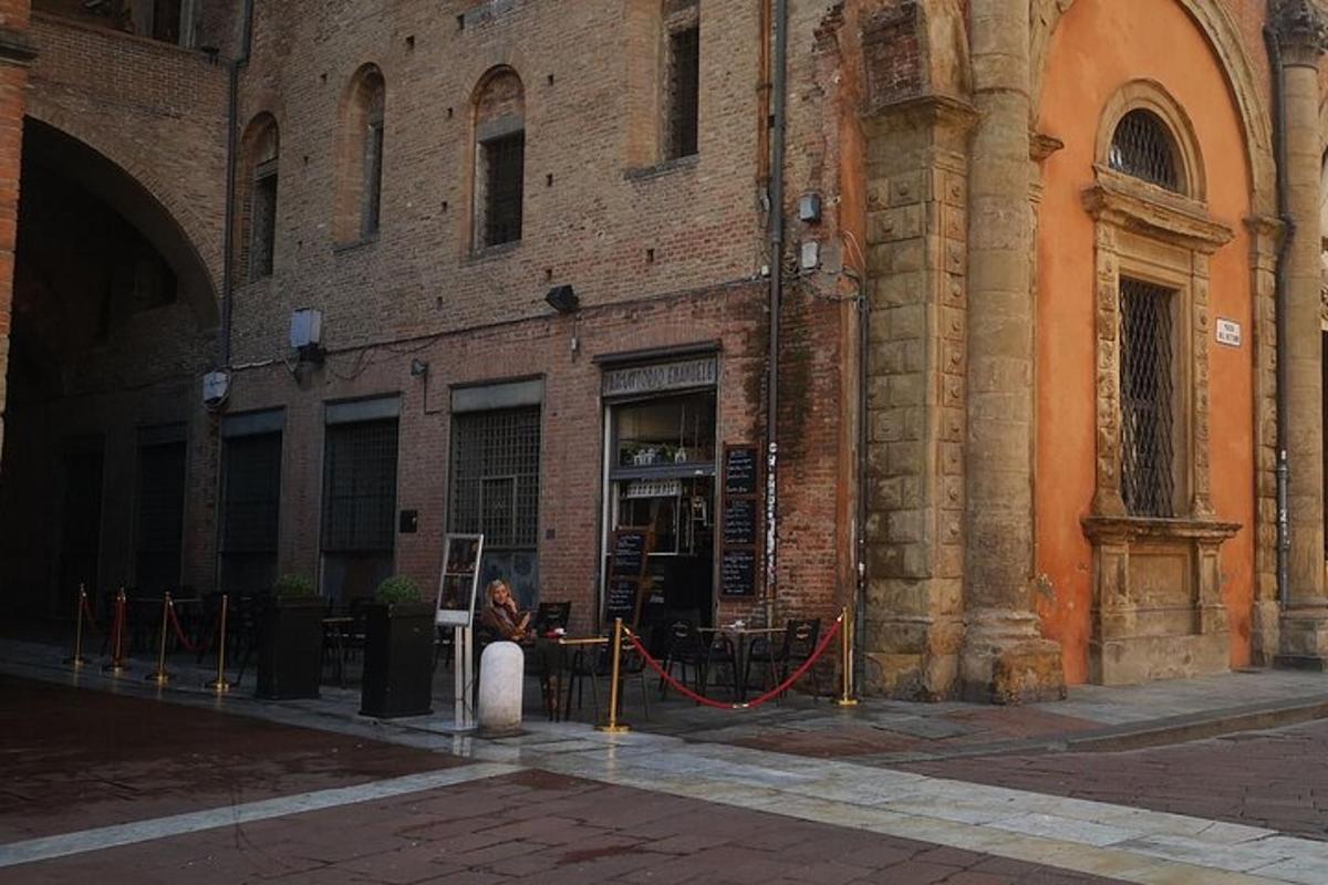 una dona asseguda en un banc davant d'un edifici