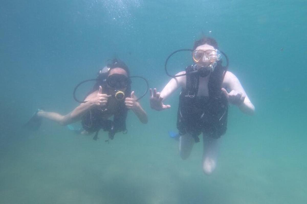 two people in the water taking pictures in the water