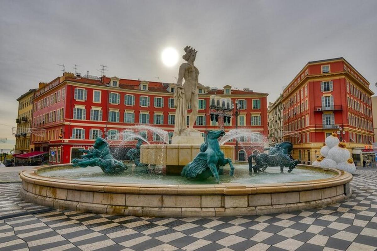 strūklaka ar statuju ēkas priekšā