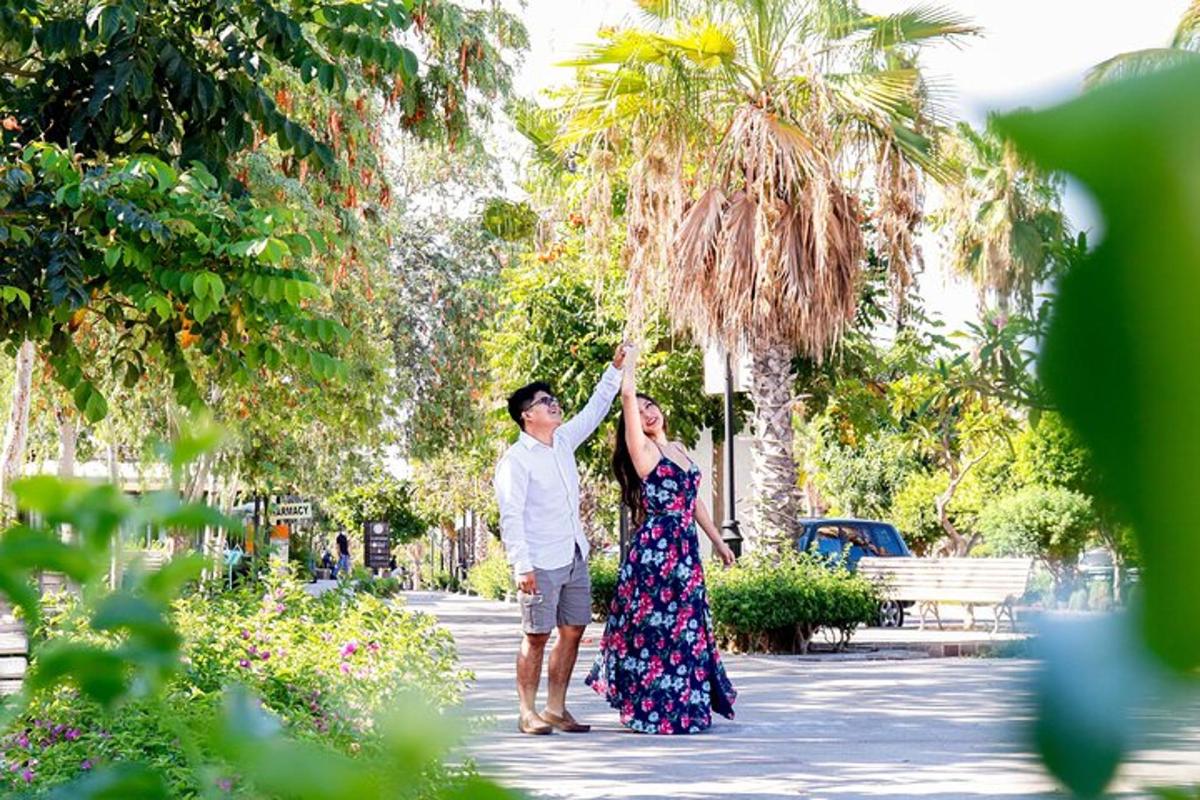 a man and a woman holding up a palm tree