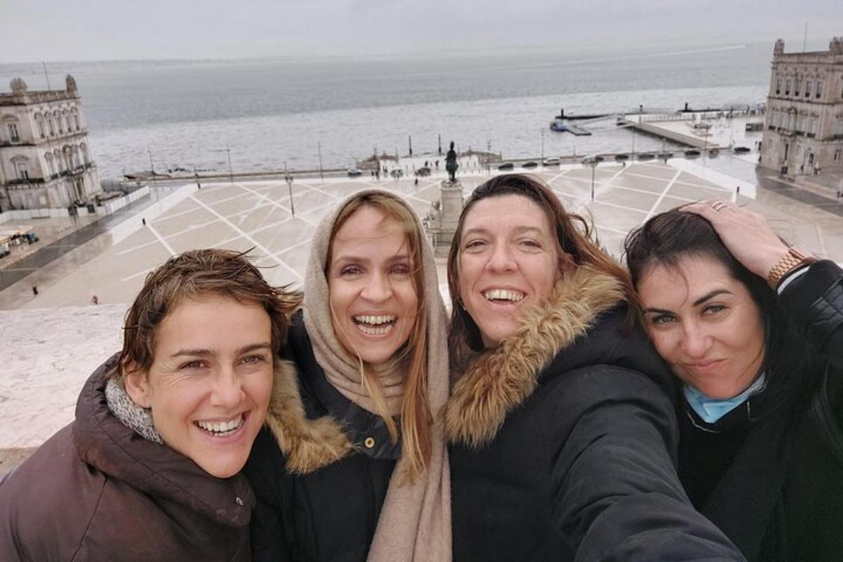 a group of women posing for a picture at the beach