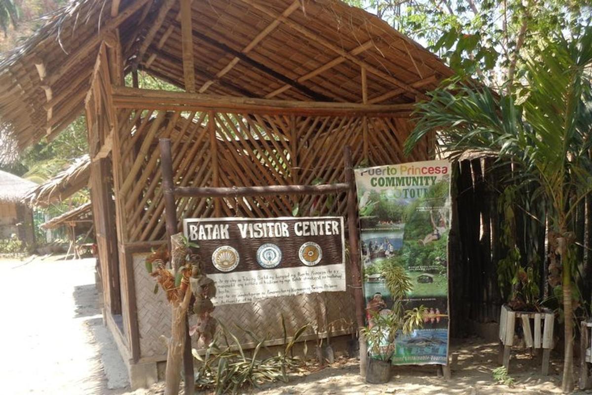 a wooden building with a sign in front of it