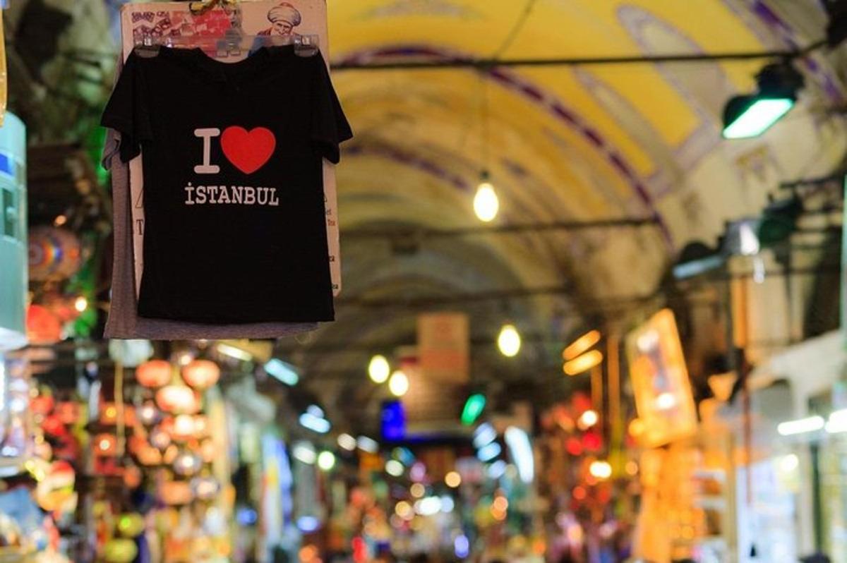 a black shirt with a heart on it hanging in a market