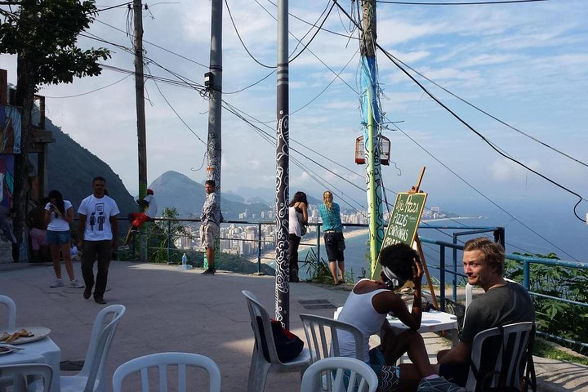 a group of people sitting at a table on a balcony