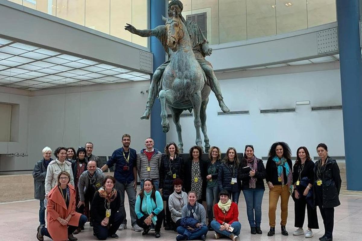 a group of people posing in front of a statue