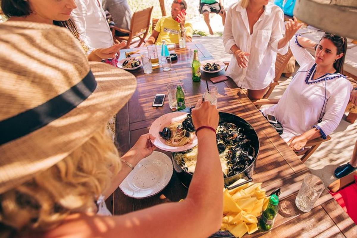 a group of people sitting around a table eating food