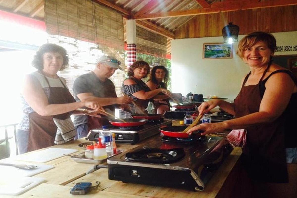 a group of people standing in a kitchen preparing food