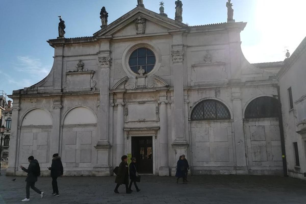 a group of people walking in front of a church