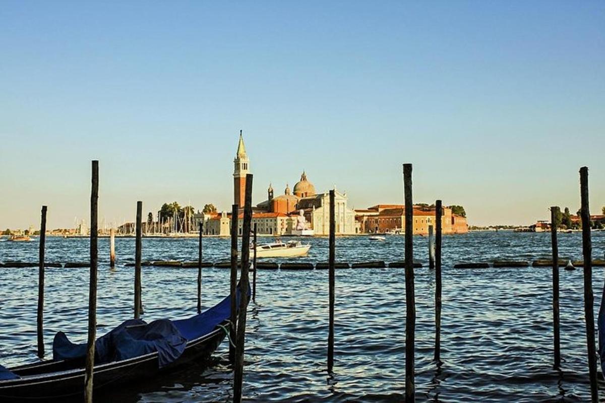 a gondola sitting in the water next to poles