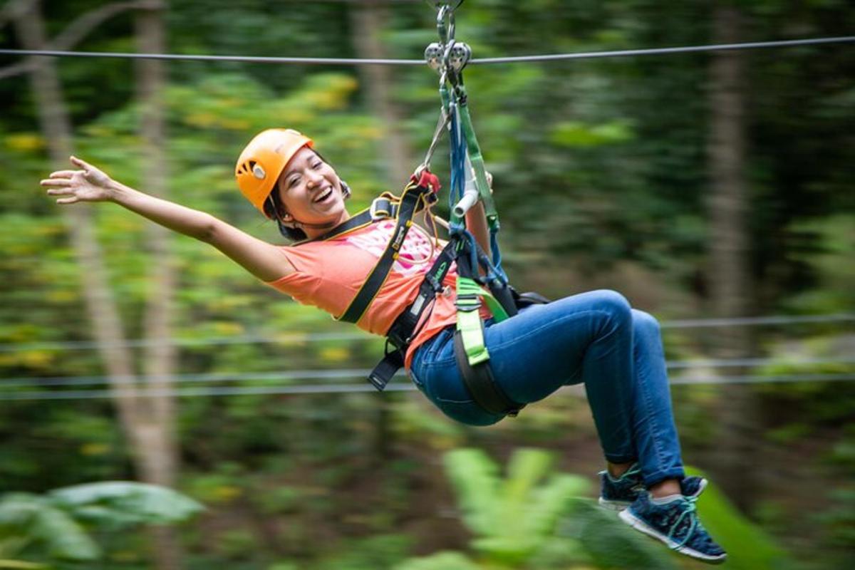 a woman is suspended in the air on a zip line