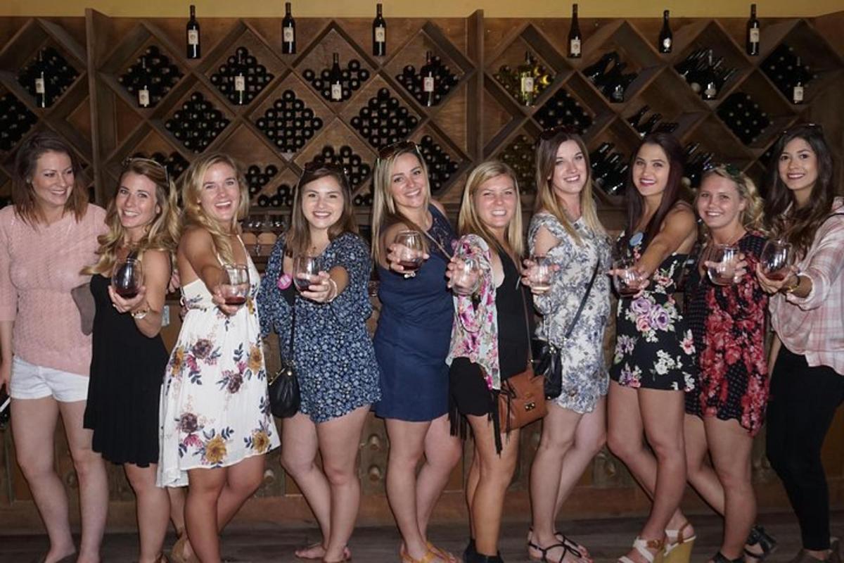 a group of women posing for a picture with wine glasses