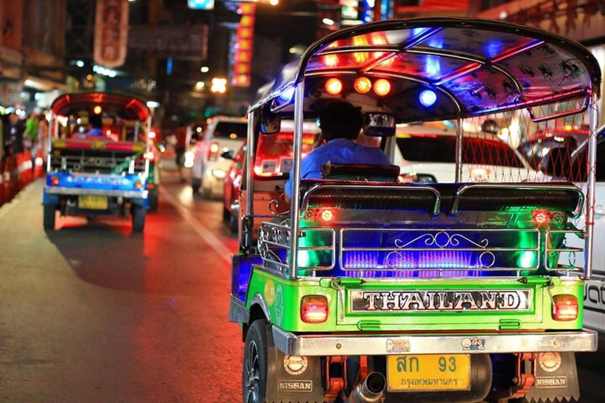 a truck driving down a busy city street at night
