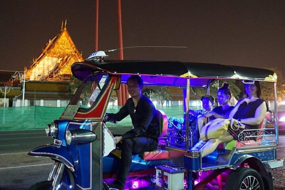 a group of people riding a golf cart at night