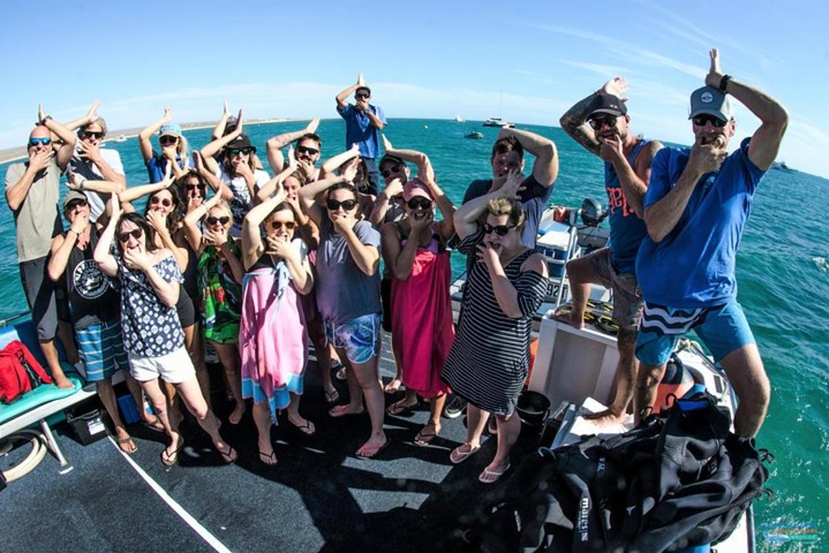 a group of people standing on a boat in the water