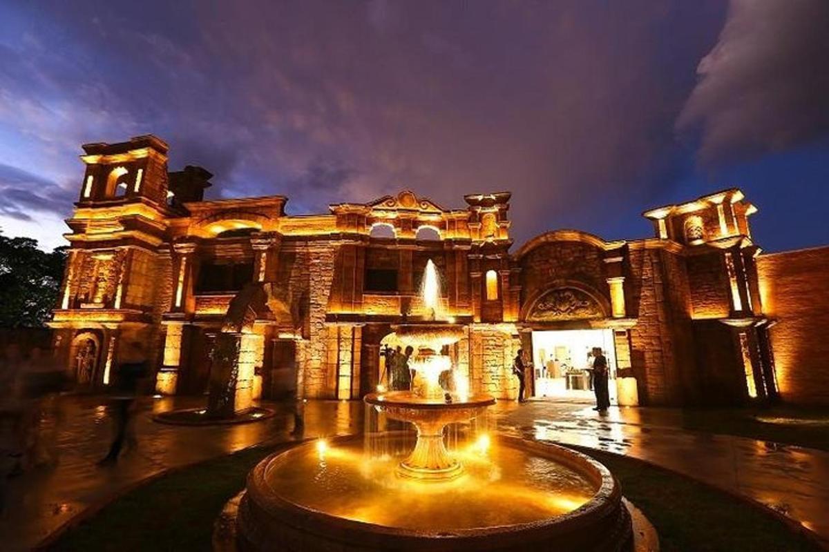 a large building with a fountain in front of it