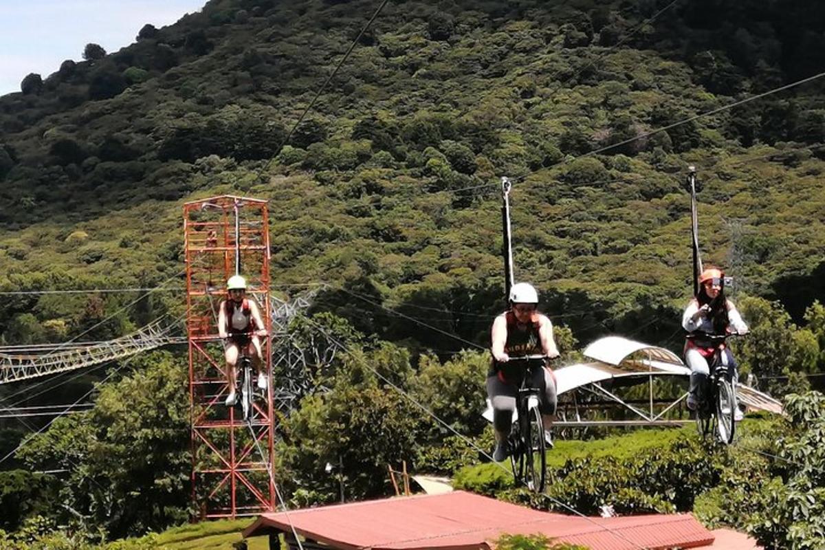 three people riding on bikes on a zip line