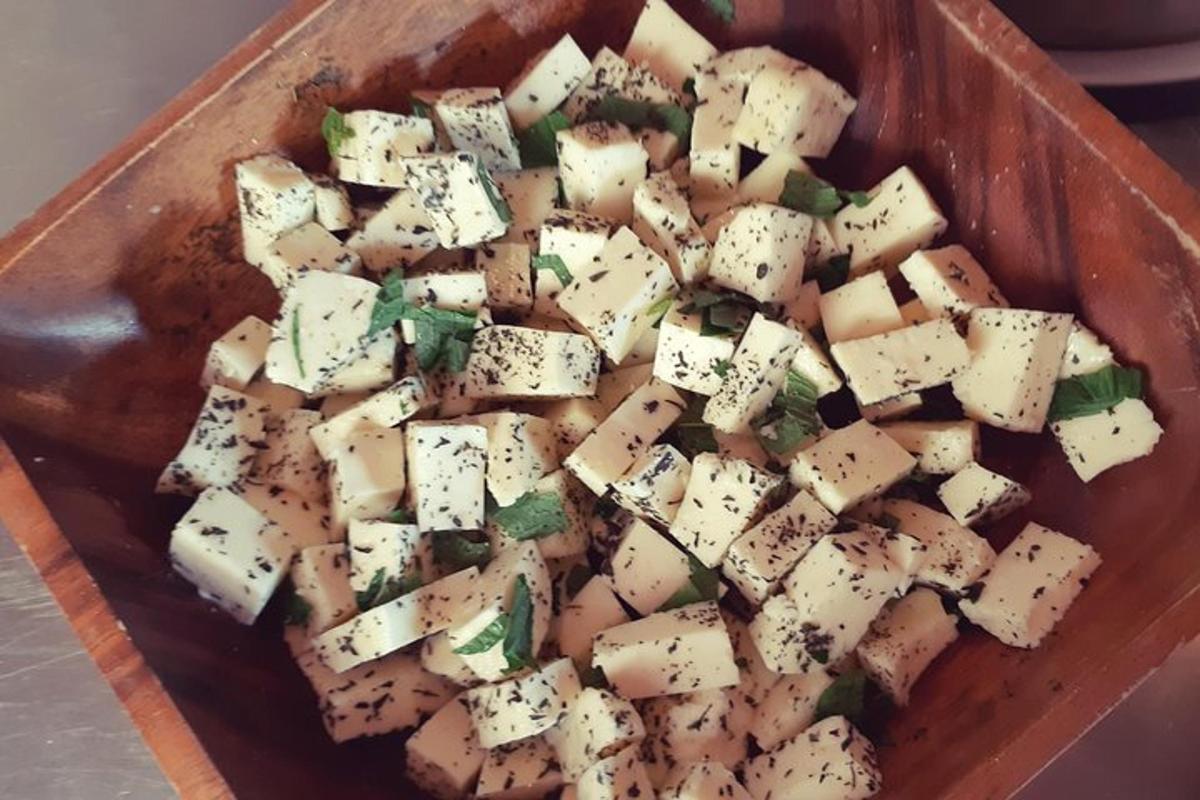 a pile of cheese cubes in a wooden bowl