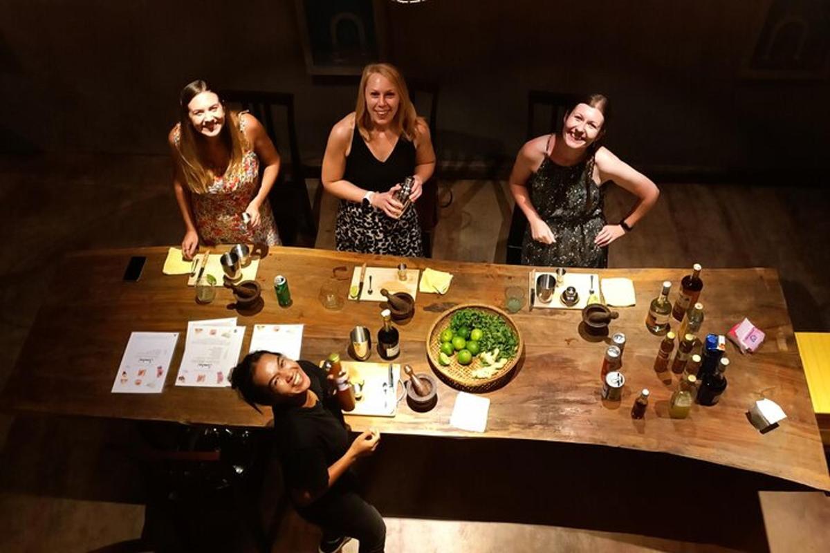 a group of people standing around a table with drinks