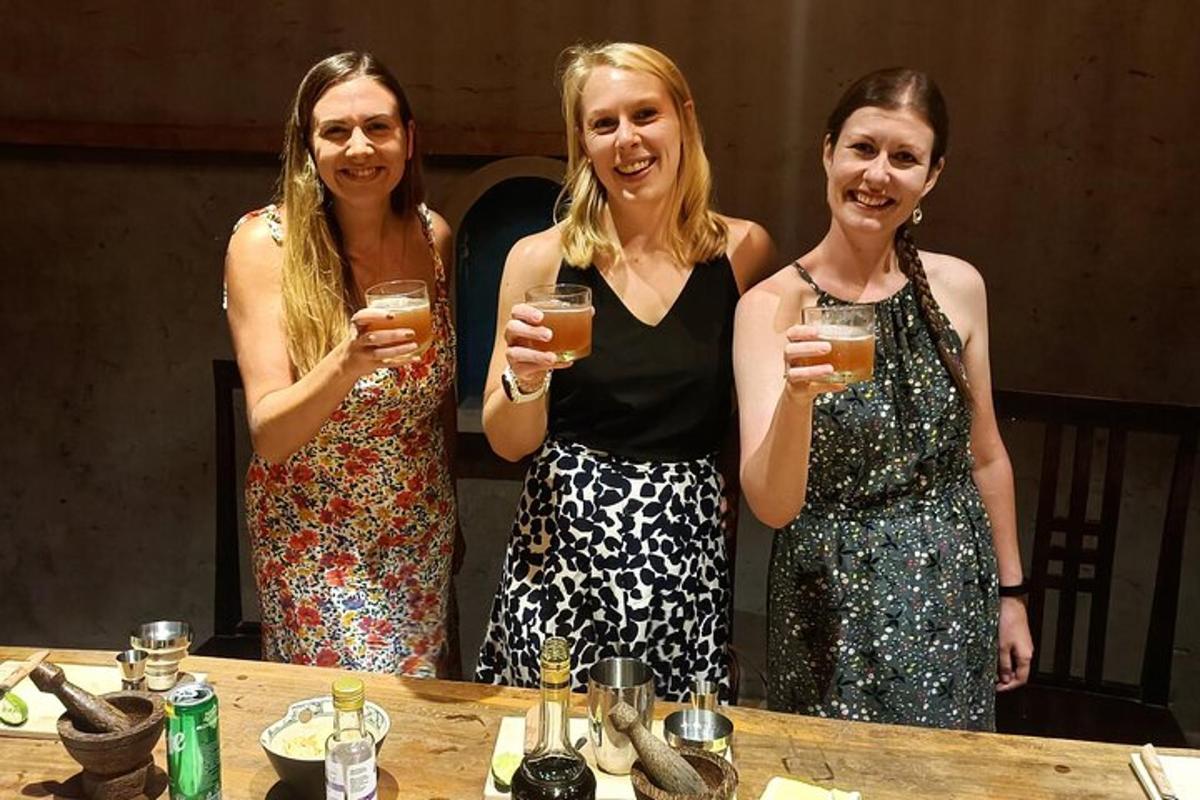 three women holding wine glasses at a table