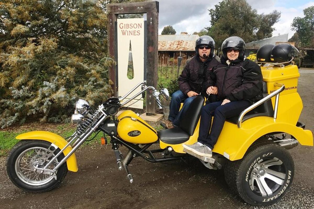 un home i una dona asseguts en una motocicleta groga