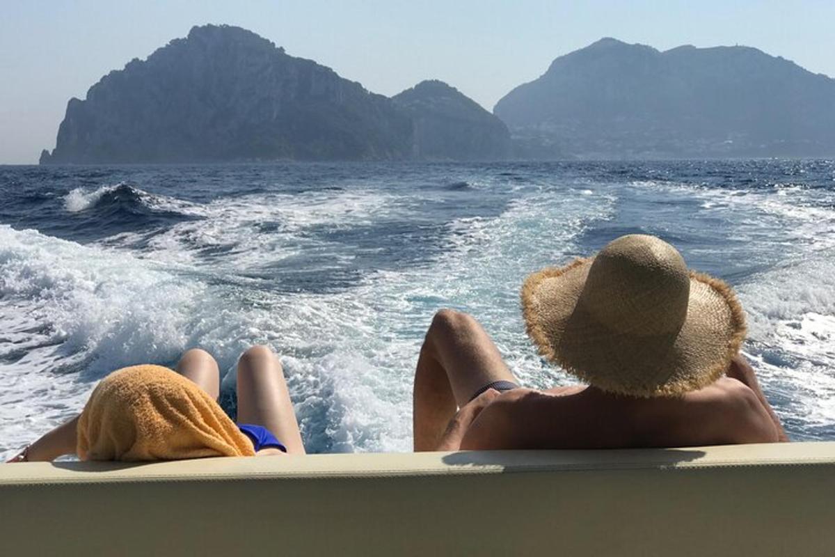 two people sitting on a boat in the water