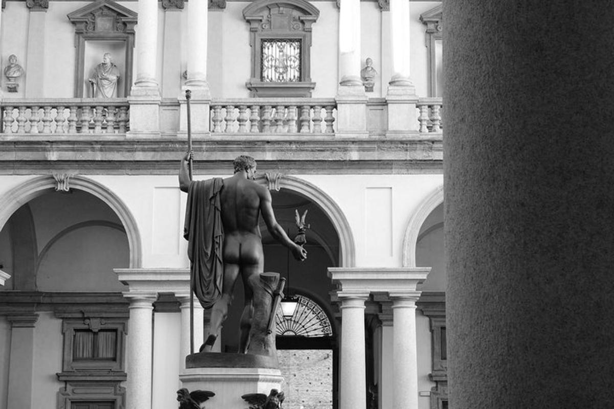 a statue of a man standing in front of a building