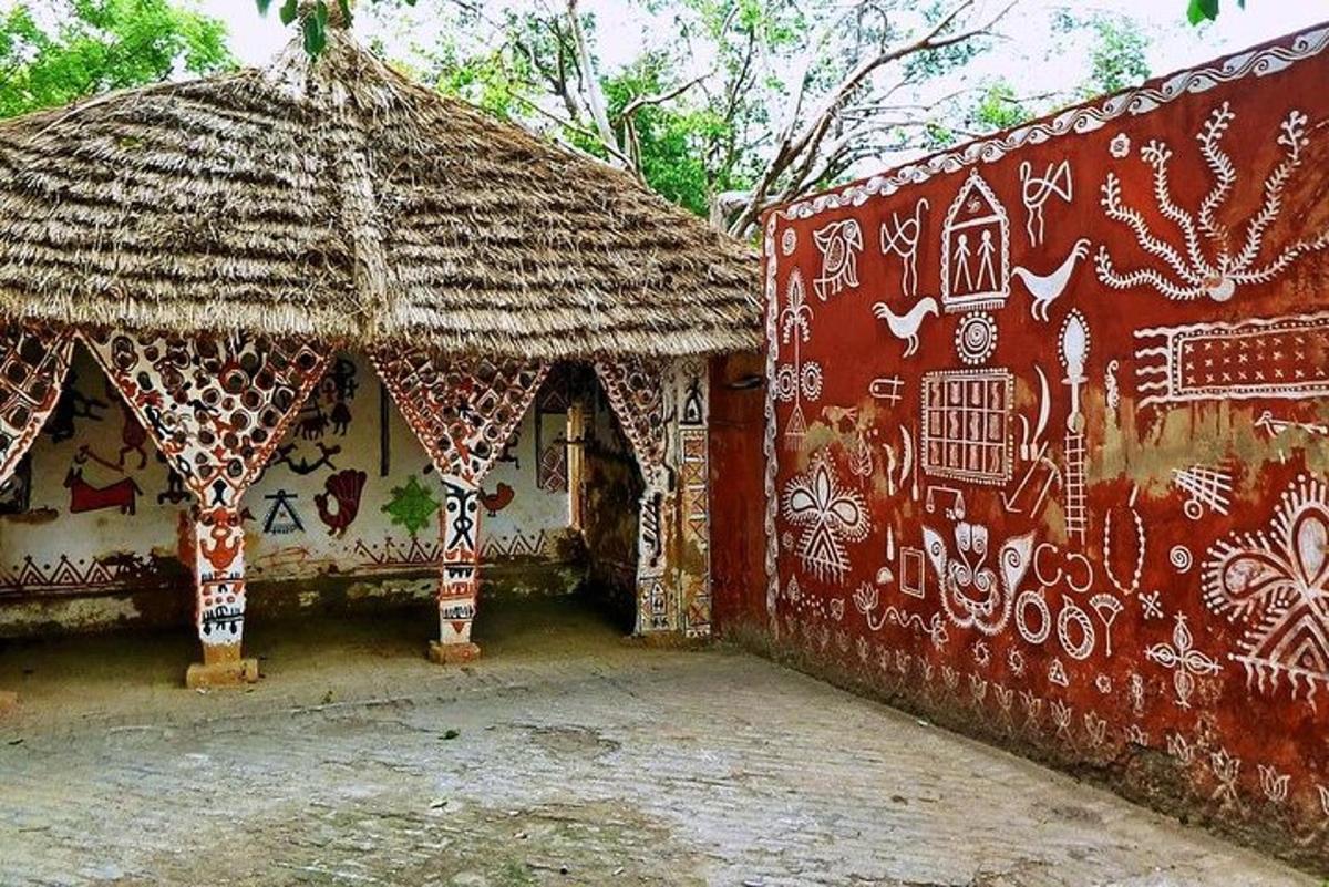 a building with a thatch roof with graffiti on it