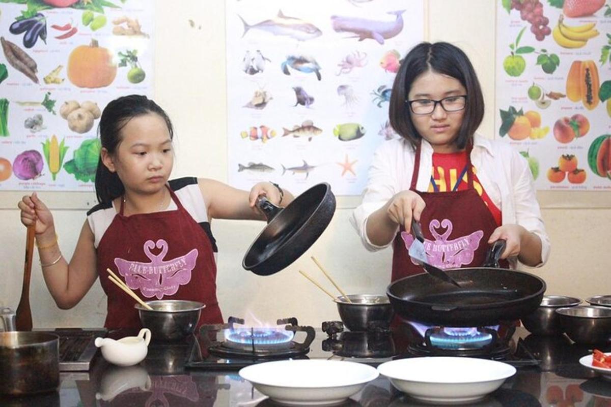 two women in a kitchen preparing food on a stove