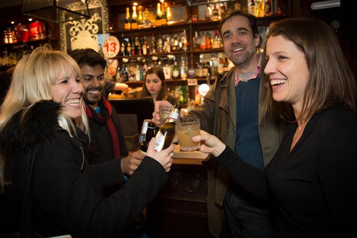 a group of people standing in a bar holding drinks