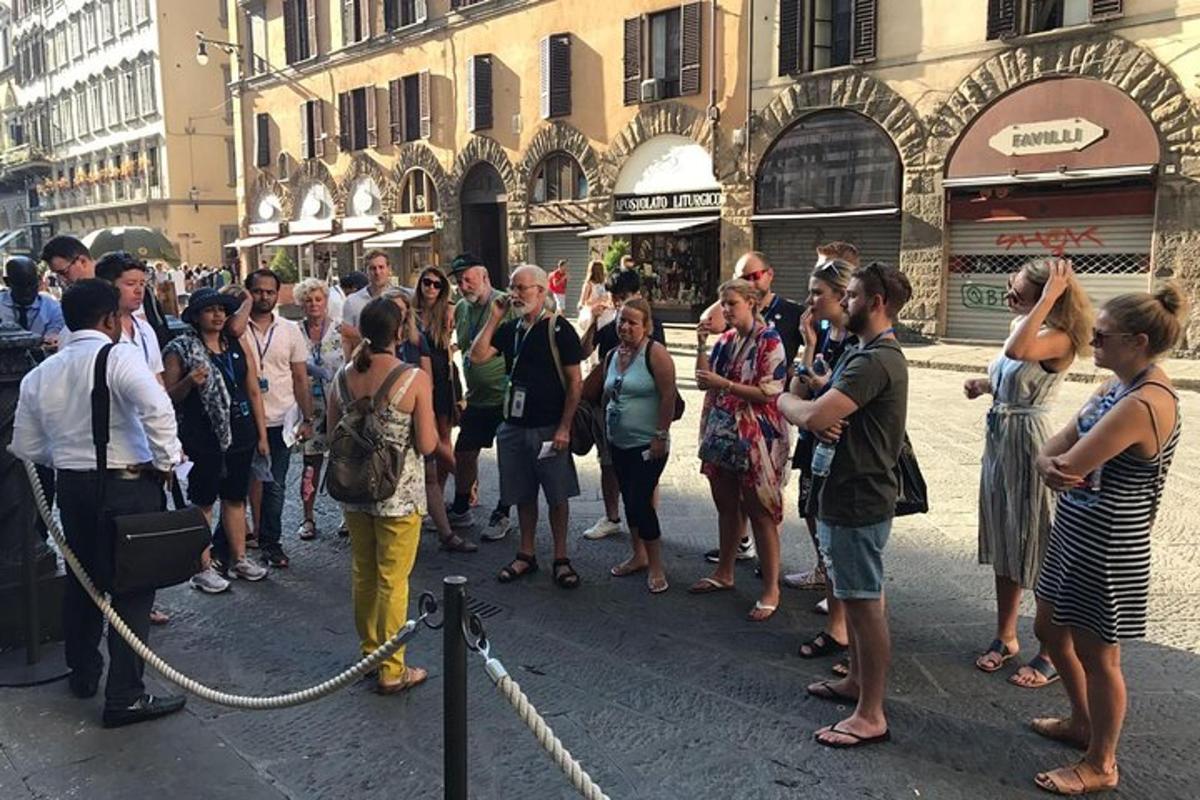 a crowd of people standing on a street in a city