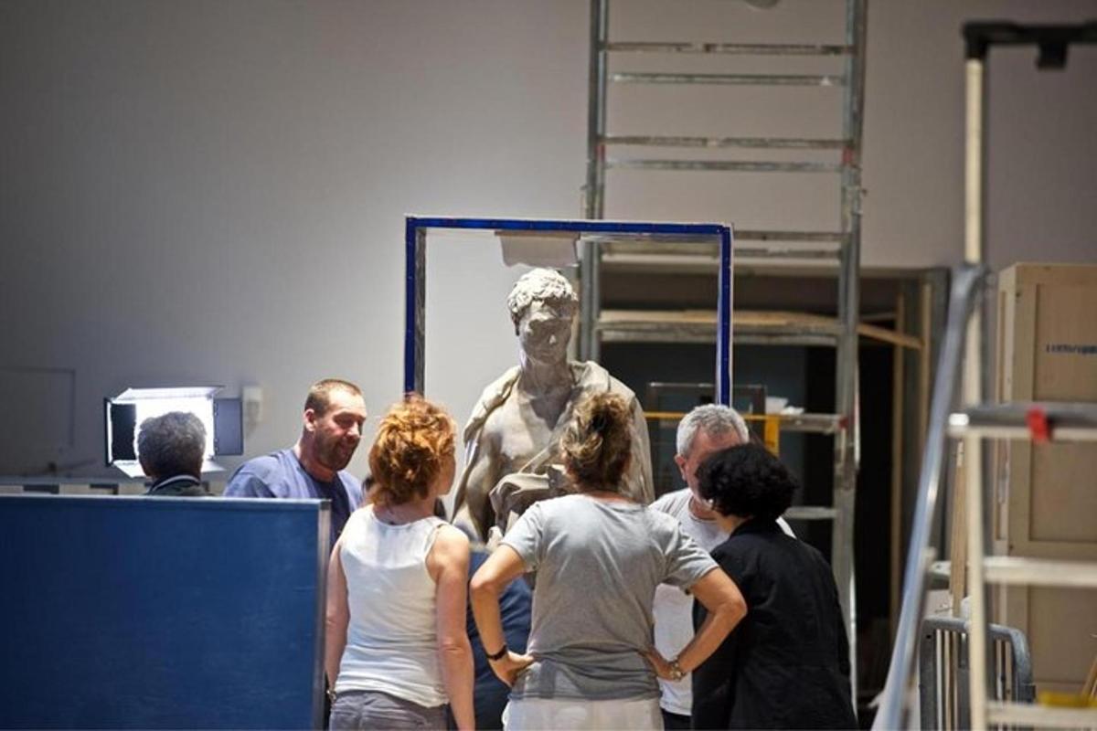 a group of people standing in front of a statue